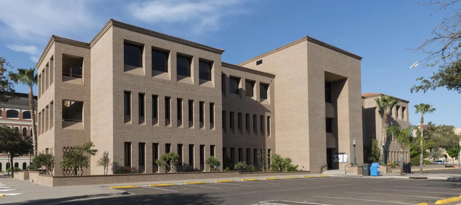 Modern city hall building in Laredo, Texas with palm trees