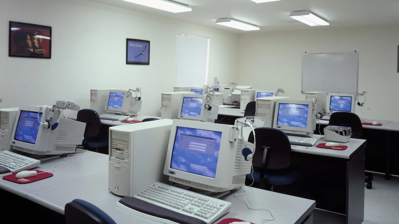 A computer lab with rows of desktop computers