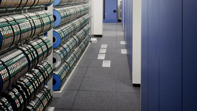 Racks of computer data storage tapes in a server room aisle