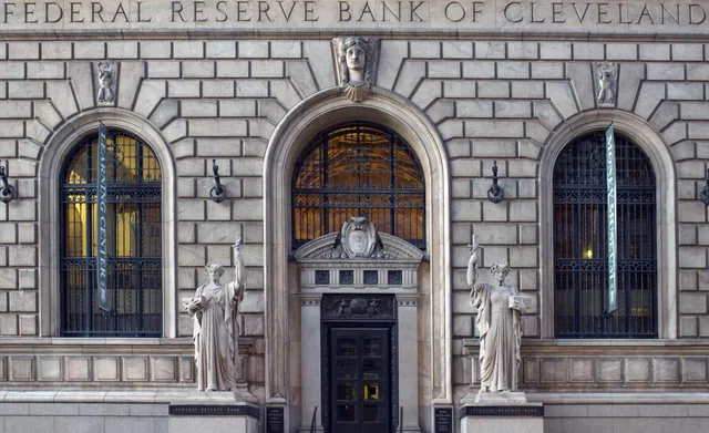 Entrance of the Federal Reserve Bank of Cleveland with its arched windows and statues