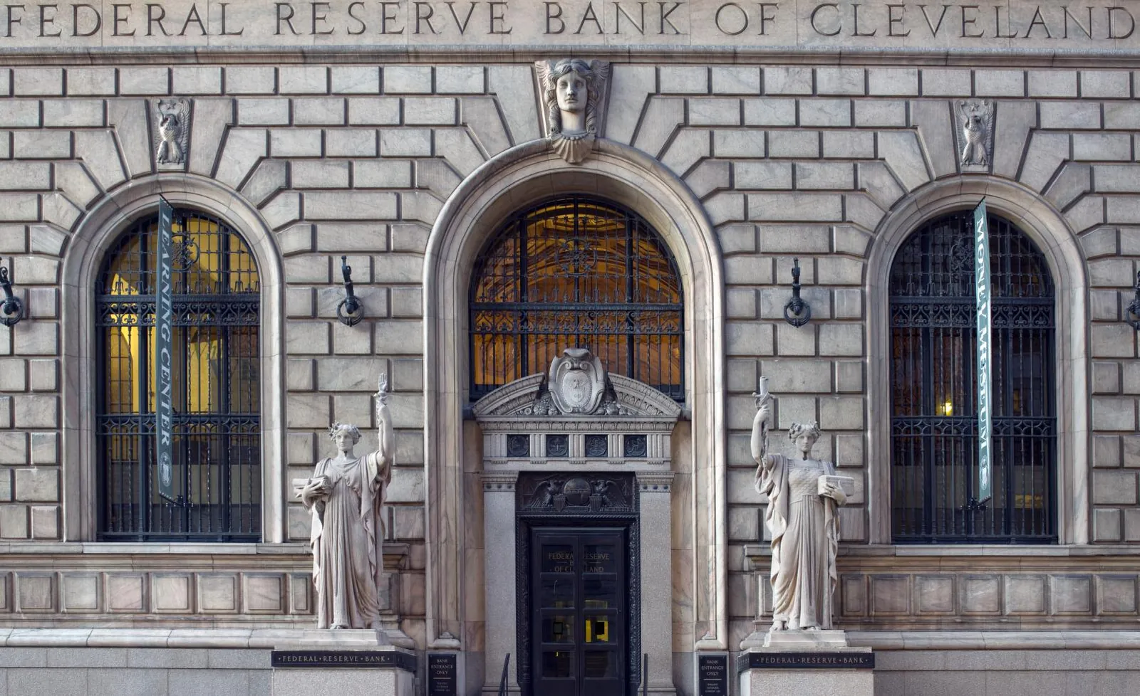 Entrance of the Federal Reserve Bank of Cleveland with its arched windows and statues