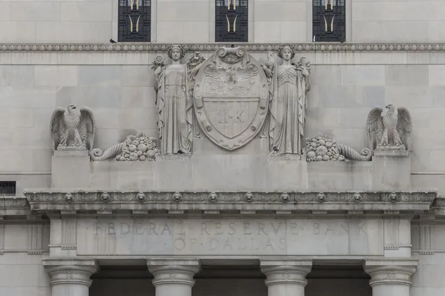 Carved stone eagles and seal above the entrance of the Federal Reserve Bank of Dallas