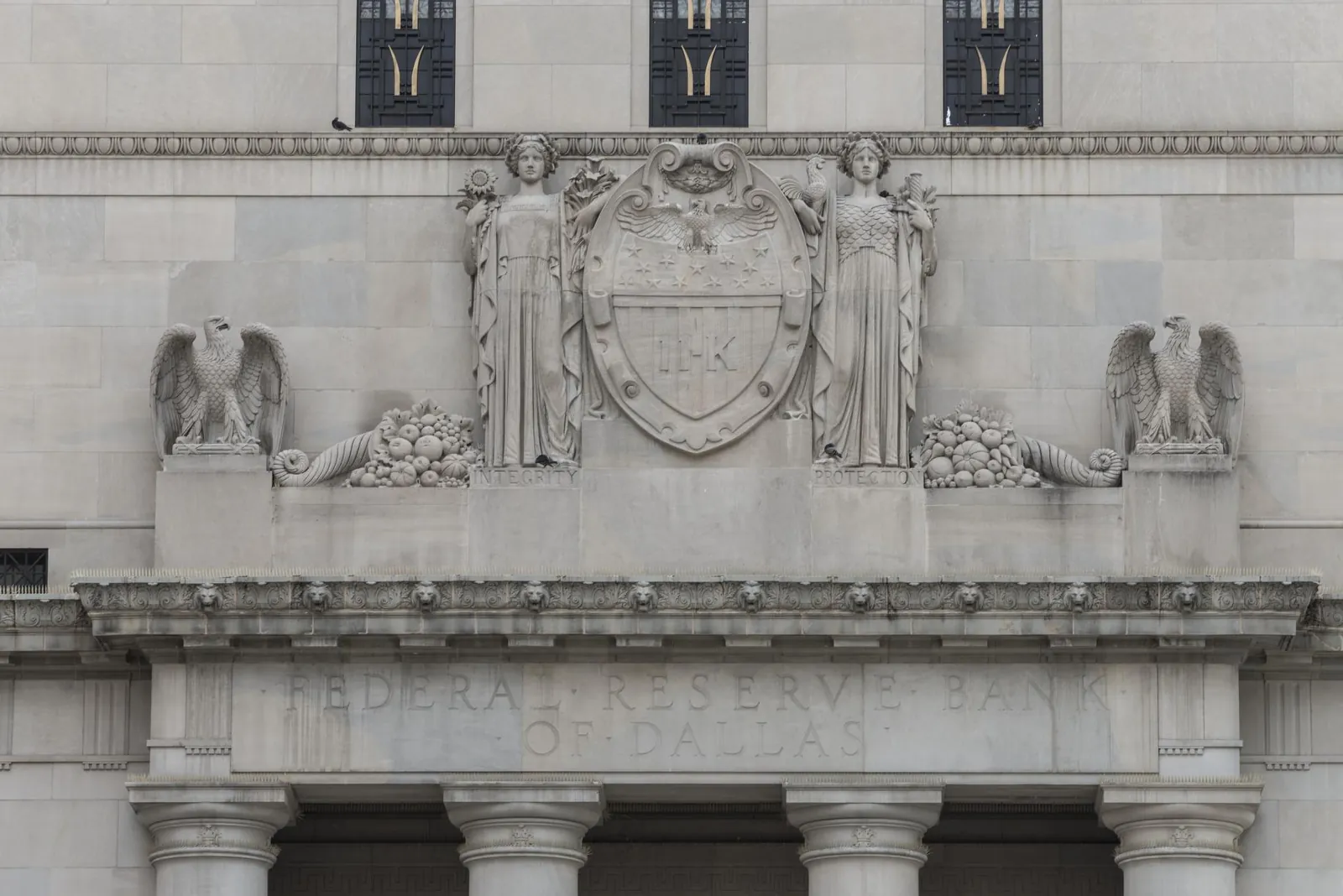 Carved stone eagles and seal above the entrance of the Federal Reserve Bank of Dallas