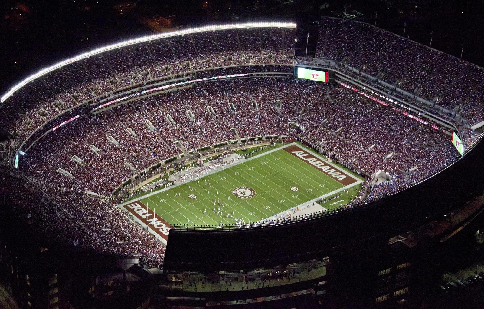 Aerial night view of a packed college football stadium in Tuscaloosa, Alabama