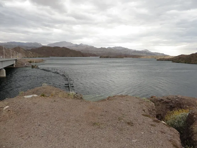 Lake Mohave and the shoreline near Davis Dam under a cloudy sky