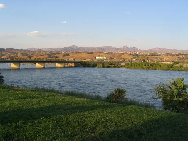 The Colorado River at Laughlin, Nevada, with a bridge and desert hills in the distance