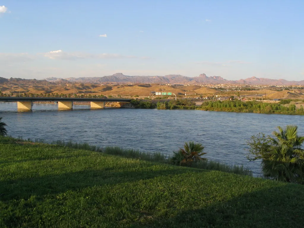 The Colorado River at Laughlin, Nevada, with a bridge and desert hills in the distance