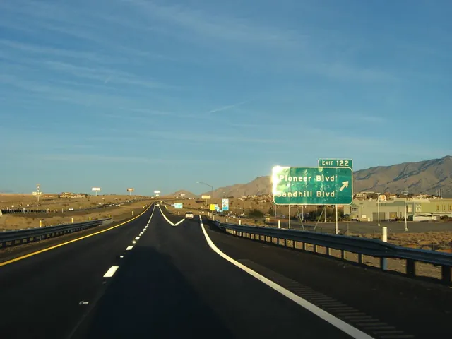 Interstate 15 approaching Mesquite, Nevada, with an exit sign and desert mountains