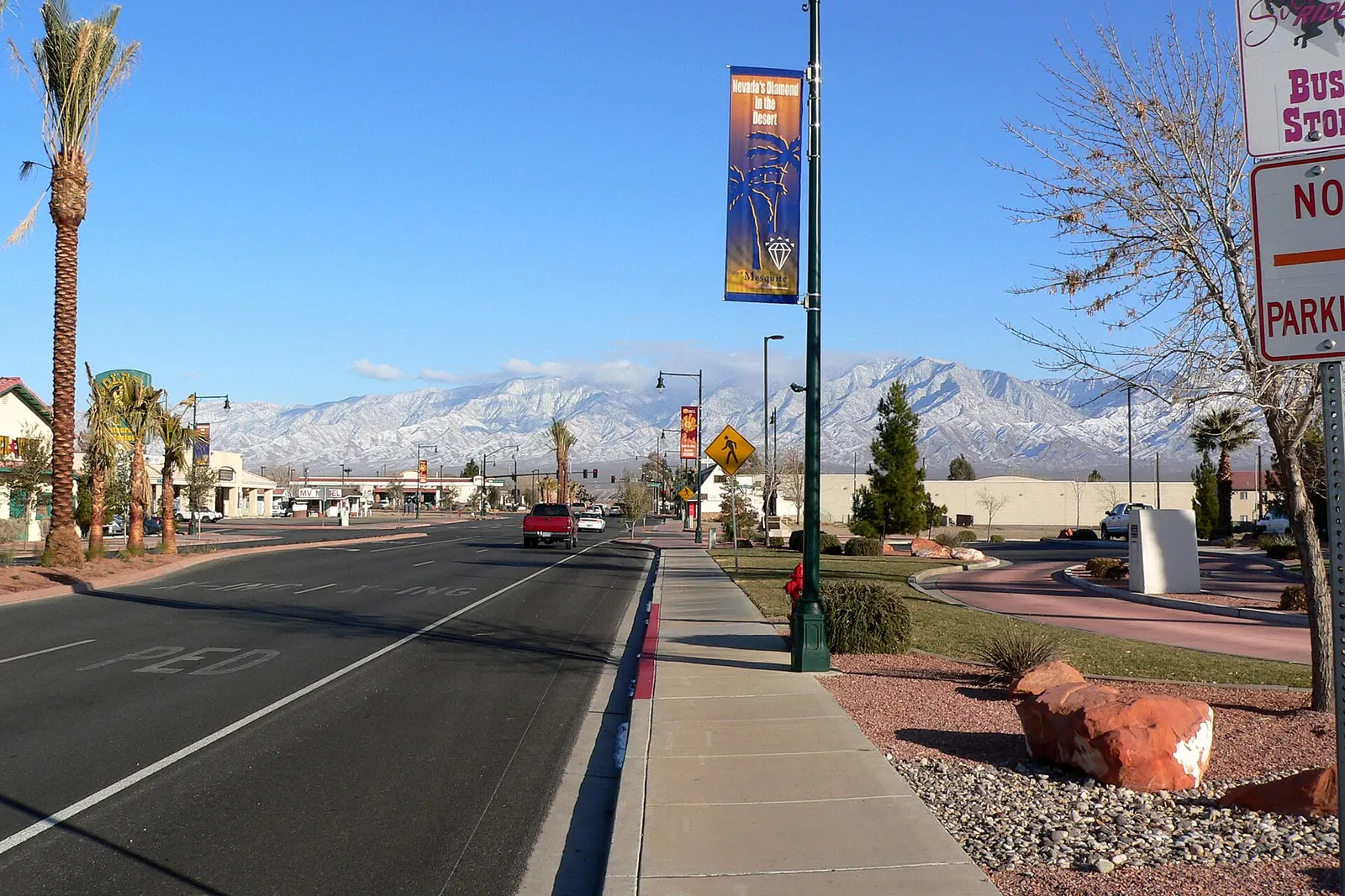 Street near city hall in Mesquite, Nevada, with snow-capped mountains in the distance