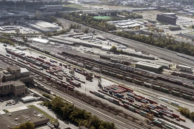 Aerial view of a rail freight yard in Cincinnati with rows of freight cars