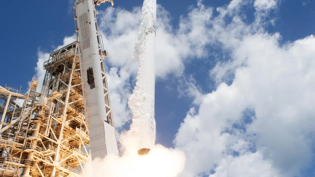 A rocket lifting off from a launch pad at Kennedy Space Center