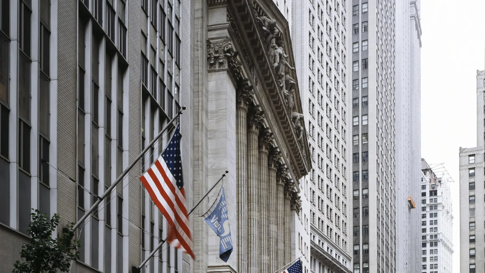 Wall Street in New York's Financial District with flags hanging from buildings