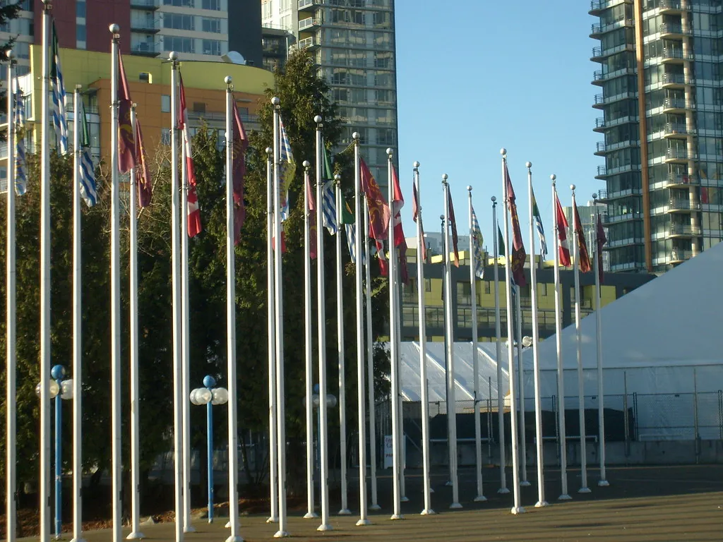 Row of international flags on flagpoles in Vancouver